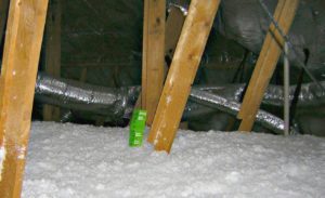 Blown-in fiberglass insulation in an attic