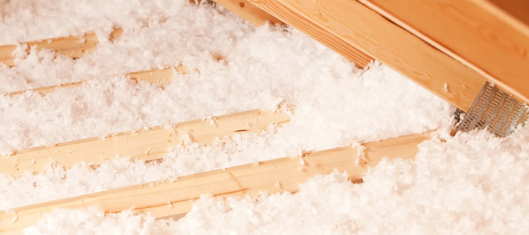 blown insulation between attic trusses